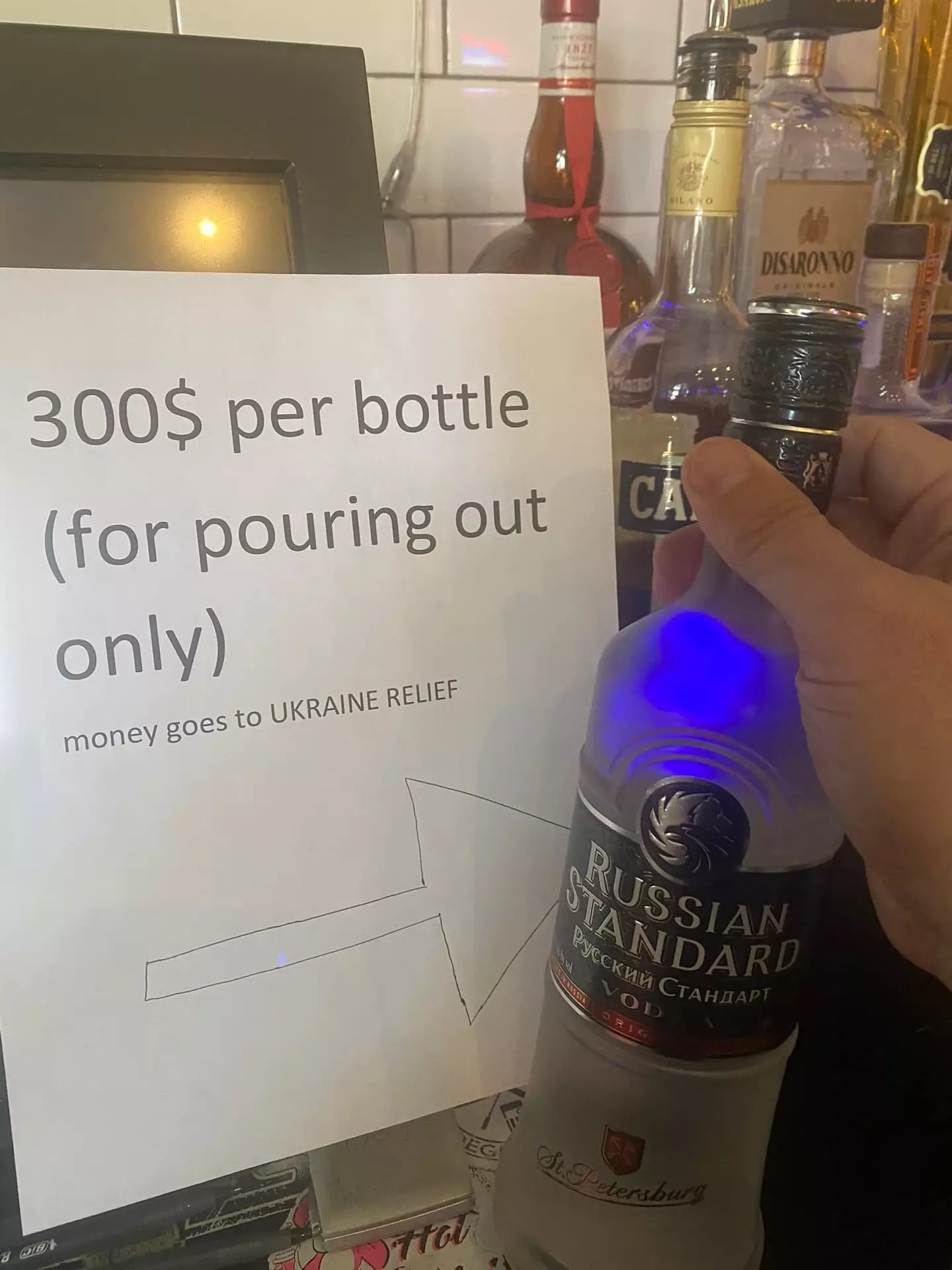People are paying hundreds to pour Russian vodka down the drain.
