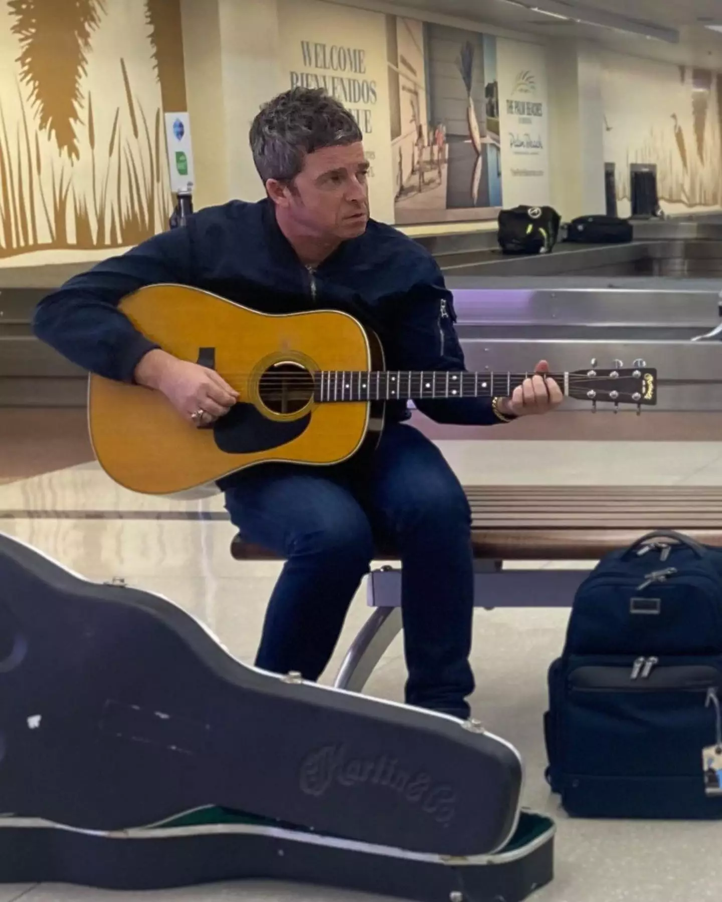 Noel Gallagher got out his guitar for a performance at Palm Beach airport.