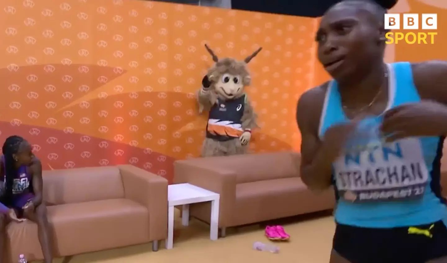 The athlete leapt out of her seat and ran towards the camera.