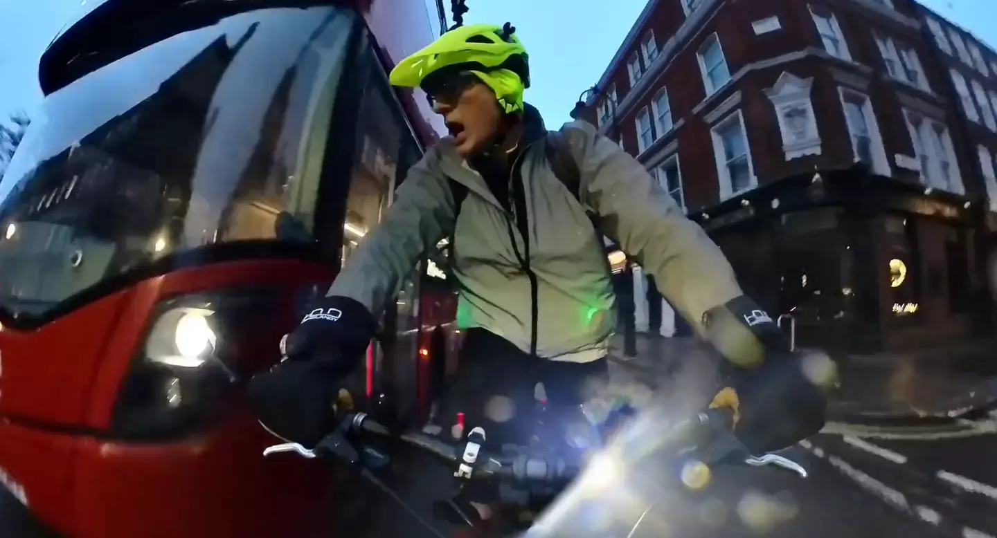 The Radio 2 host shouts 'woah' as a double-decker bus overtakes him on his right-hand side.