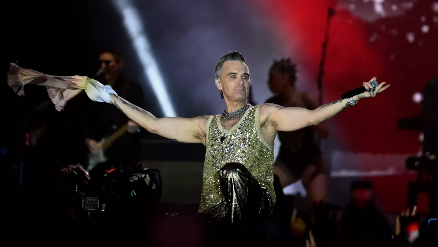 Fans were leaving the concert when the woman fell trying to step over seating rows.