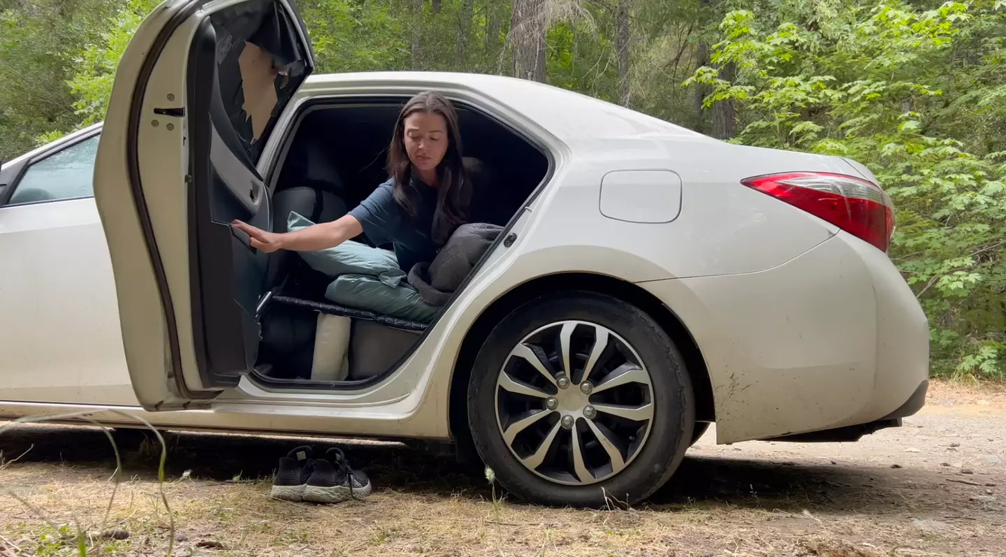 She sleeps on a matress across the back seats.