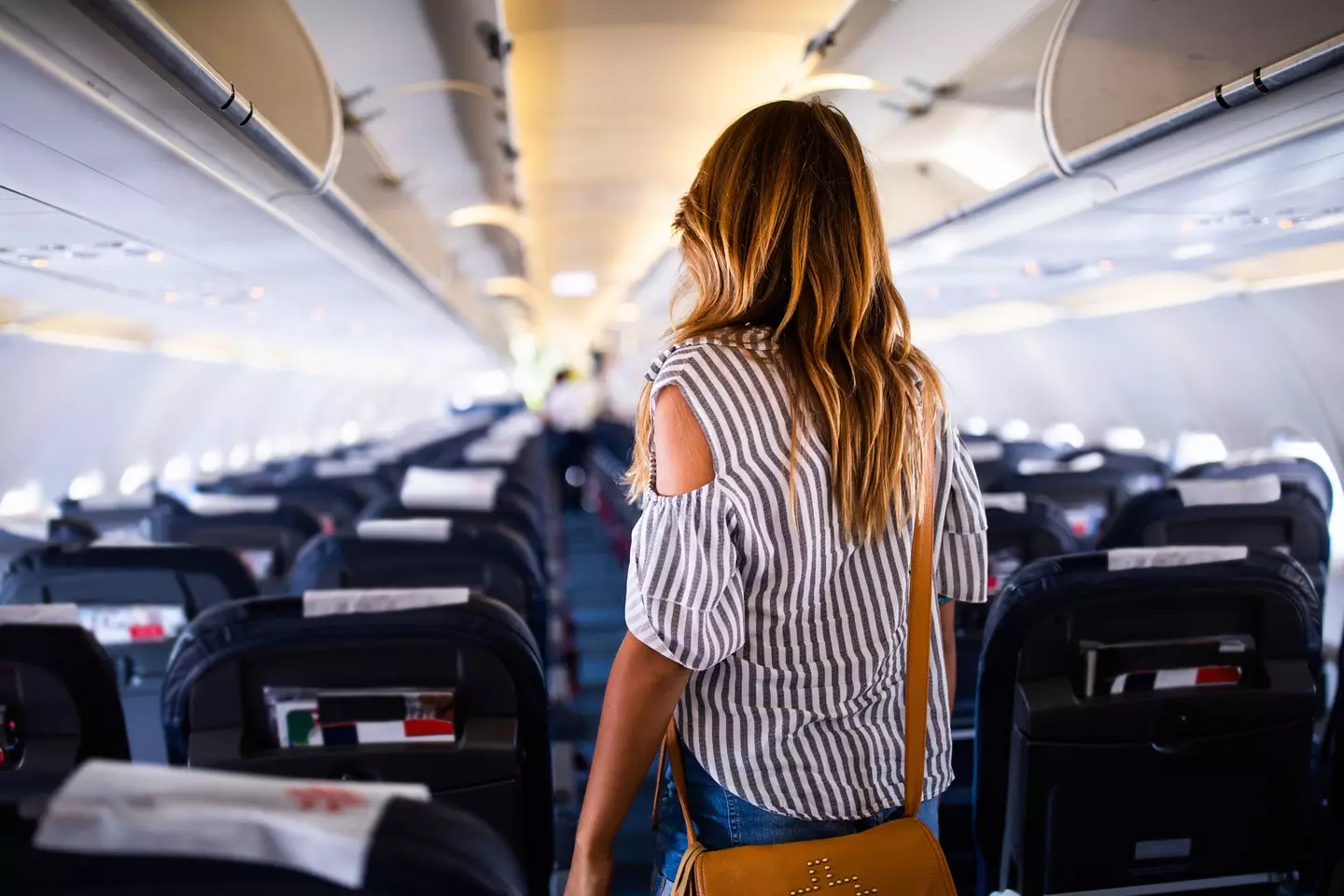 Have you ever wondered why you're greeted by cabin crew as you board the plane? (Getty Stock Image)