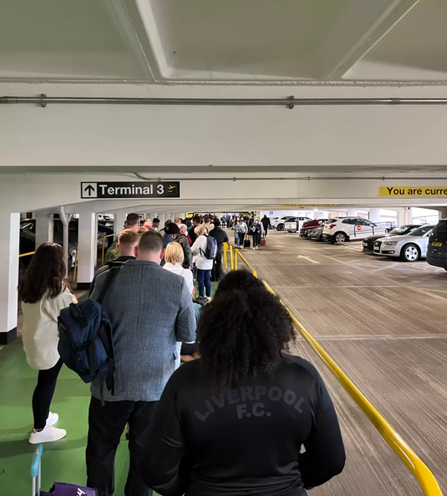 Pictures have emerged of queues at Manchester Airport snaking into the carpark.
