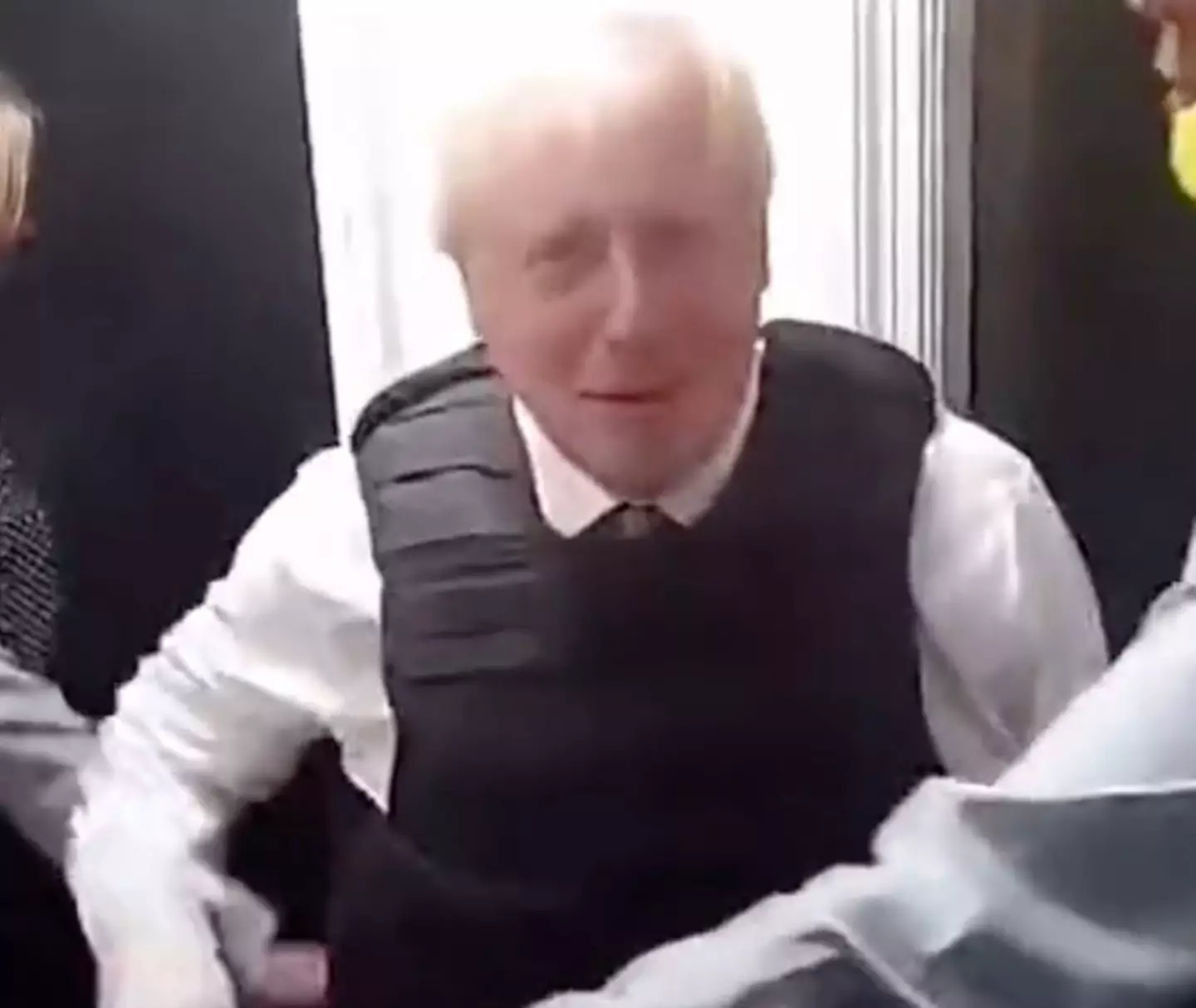 The prime minister appeared to try and wave at the camera at one point.