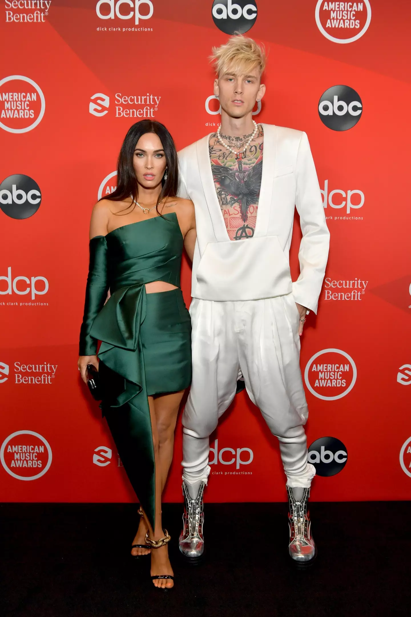 MGK, seen with Megan Fox in 2020, has now covered up his torso tatts.