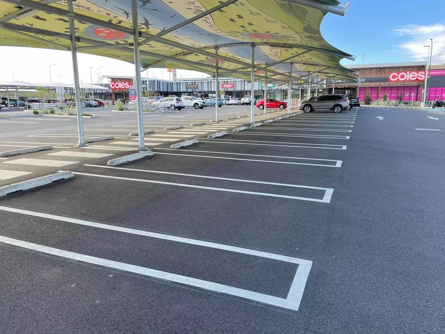 Parking spaces are separated by rectangles instead of white lines.