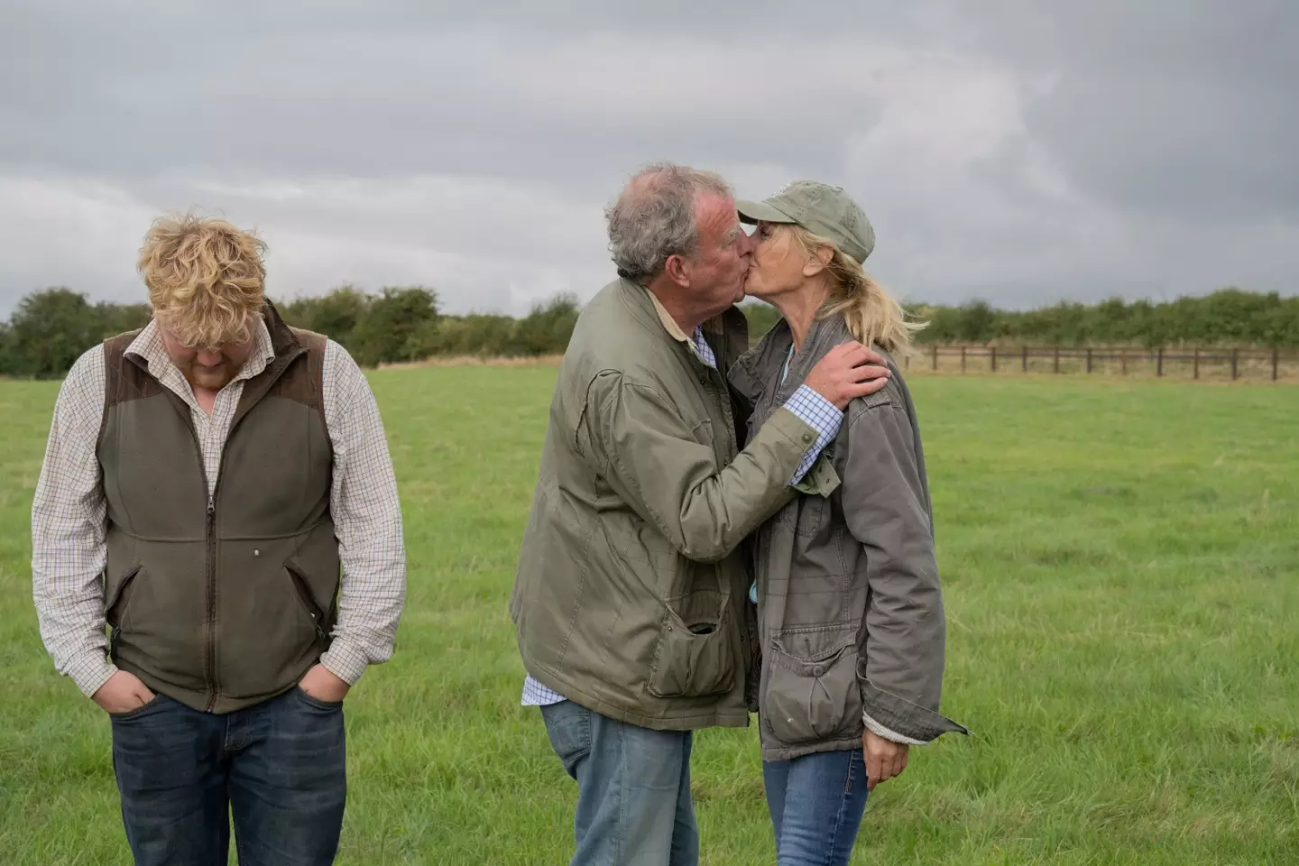 Jeremy giving his girlfriend Lisa a smooch while Kaleb stands there rather awkwardly (PA/Ellis O'Brien/Prime Video)