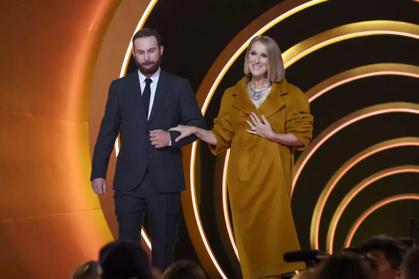 She was assisted to the front of the stage.