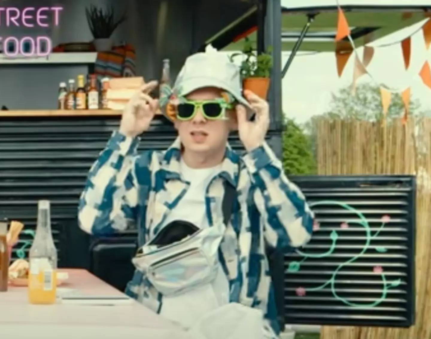 Aitch is ready for festival season with his shades and bumbag.