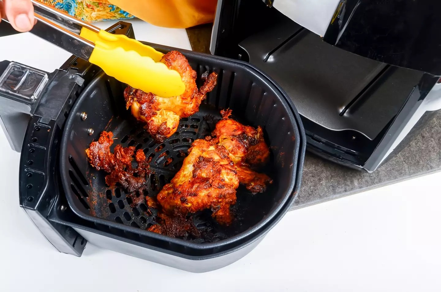 Chicken being cooked in an air fryer. Getty Stock Images