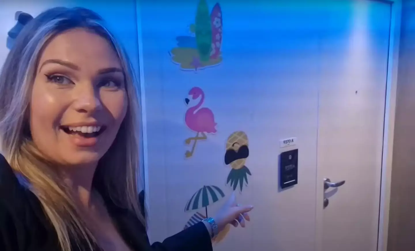 Lucy outside one of the cabins with inviting decorations (YouTube/@cruisingascrew)