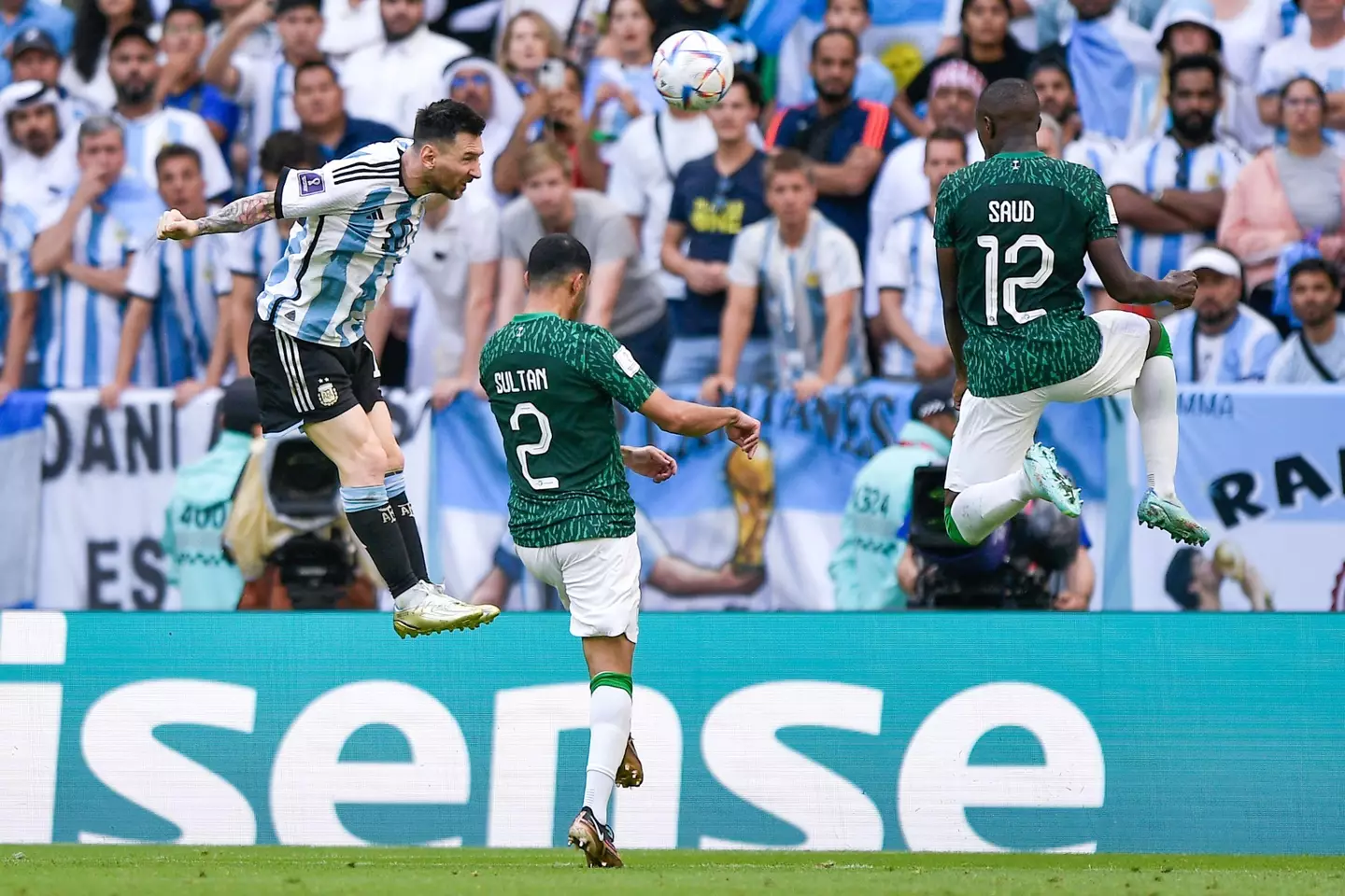 Lionel Messi of Argentinia wins a defensive header against Sultan Alghannam of Saudi Arabia.
