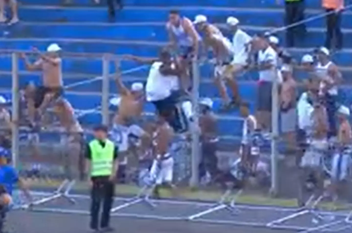 Football fans scaled fences to rush onto the pitch in Brazil. Credit:X/@geglobo
