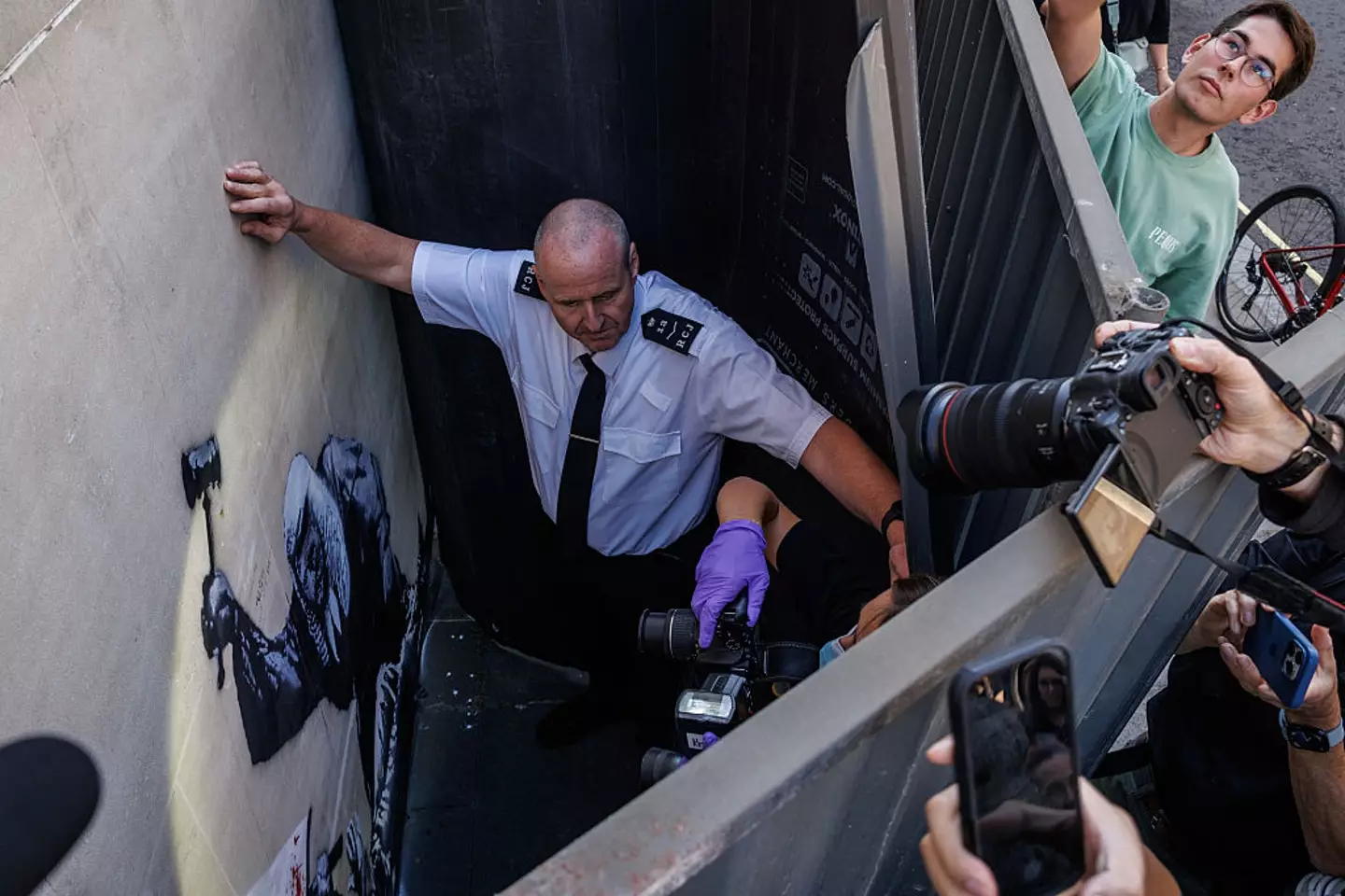 The work was covered with gates before being cleaned off (Dan Kitwood/Getty Images)