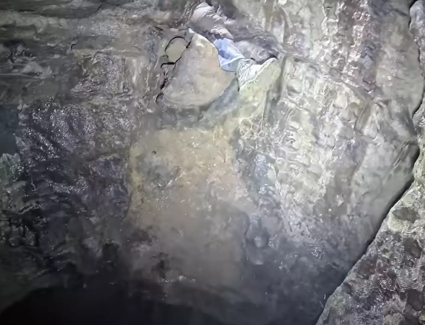 Cave explorers have to rely on insane leap of faith to cover massive chasm below 3 He left his leg out so his friend could climb up it and not fall down the chasm. (YouTube/ActionAdventureTwins)