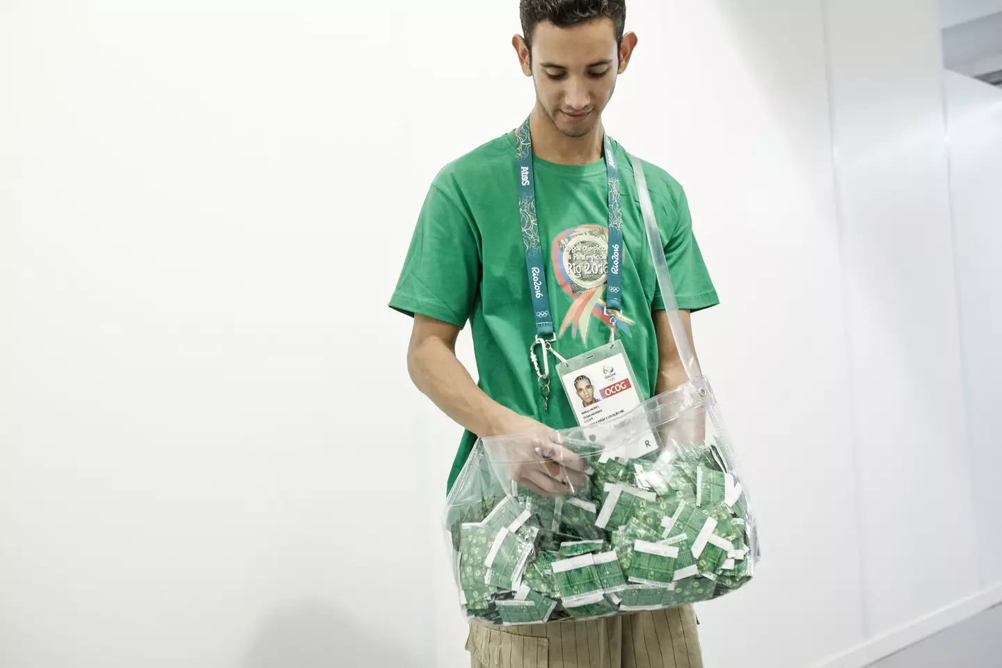 A staff member at the 2016 Rio Olympics taking condoms to refill the dispenser machines. (YASUYOSHI CHIBA/AFP via Getty Images)