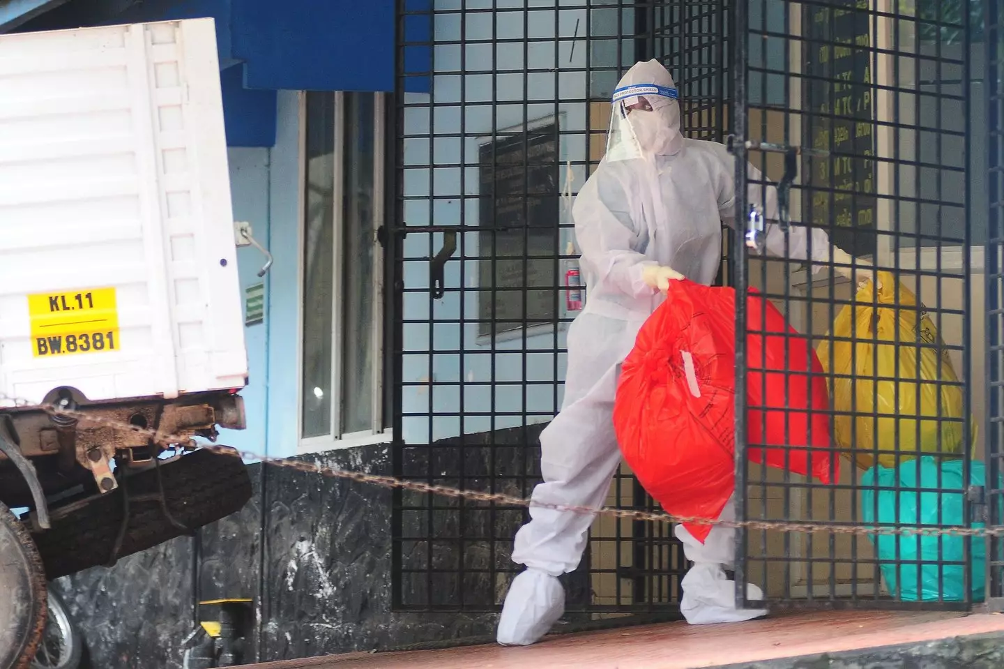 A health worker seen wearing protective gear disposes biohazard waste from a Nipah virus isolation centre during an outbreak in India in 2023 (AFP via Getty Images)