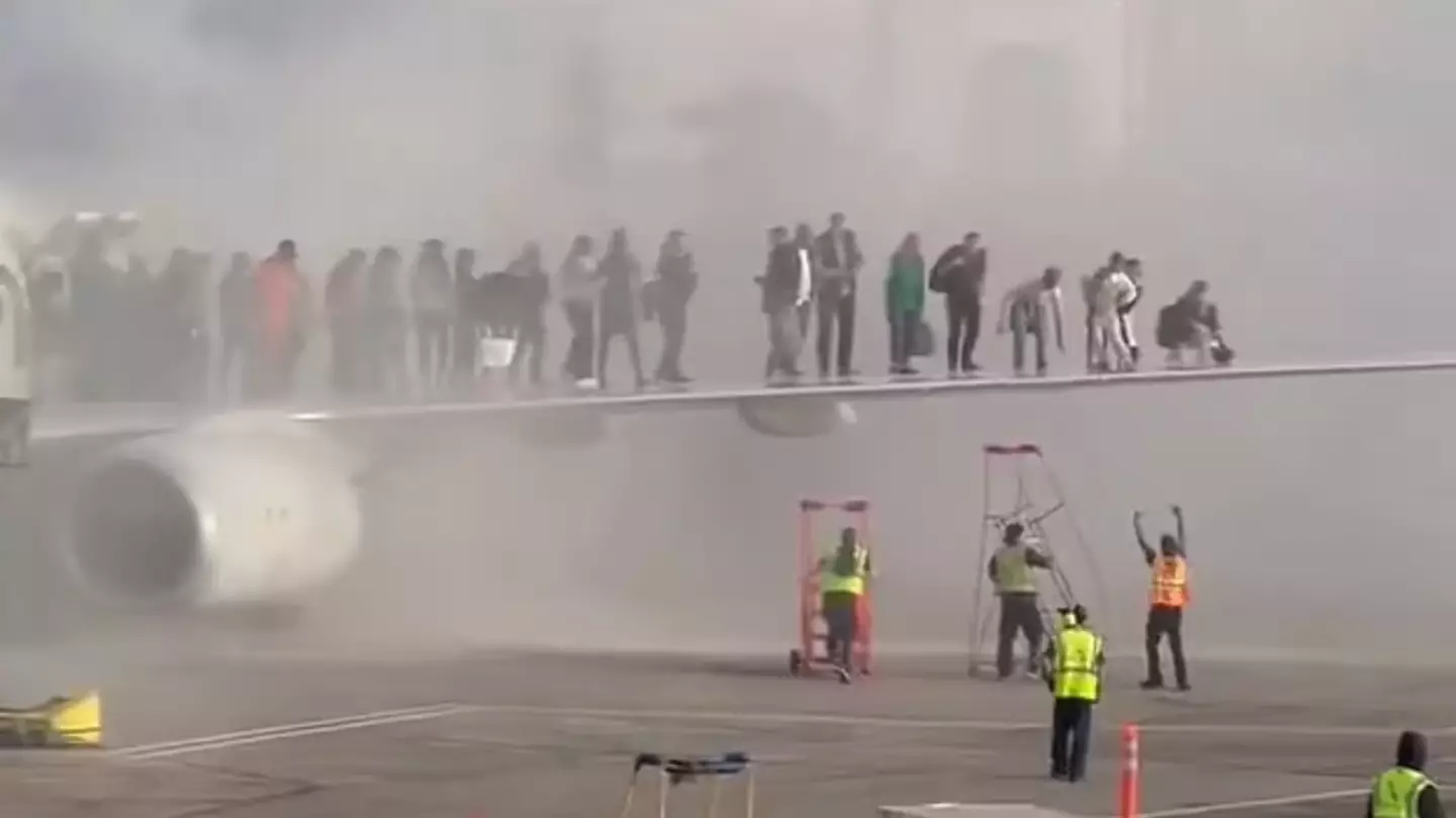 Passengers forced to escape onto wings as plane bursts into flames in terrifying scenes