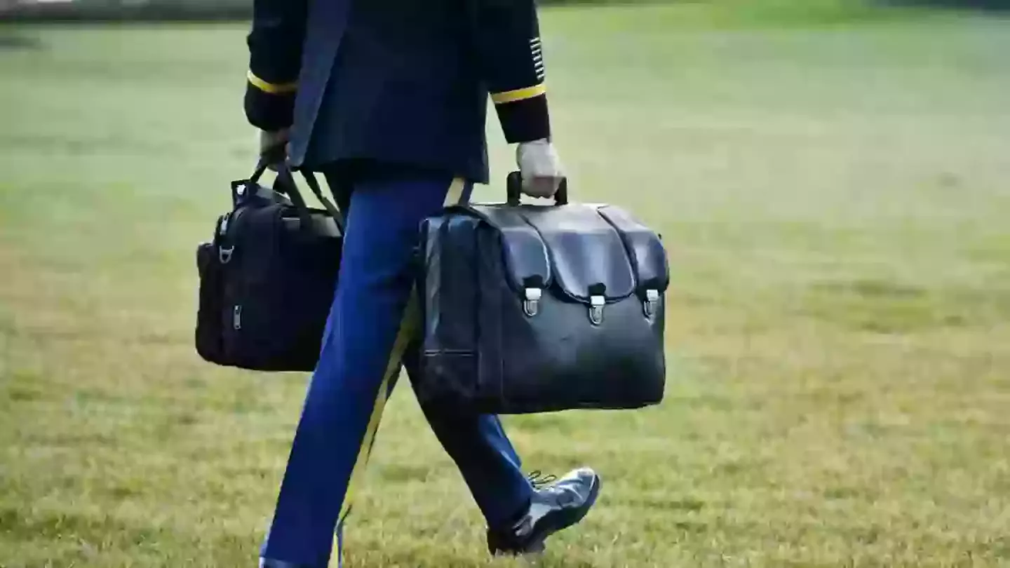 The biscuit is currently carried around in a briefcase, but it was suggested that someone carry a butcher's knife instead (BRYAN DOZIER/Middle East Images/AFP via Getty Images)