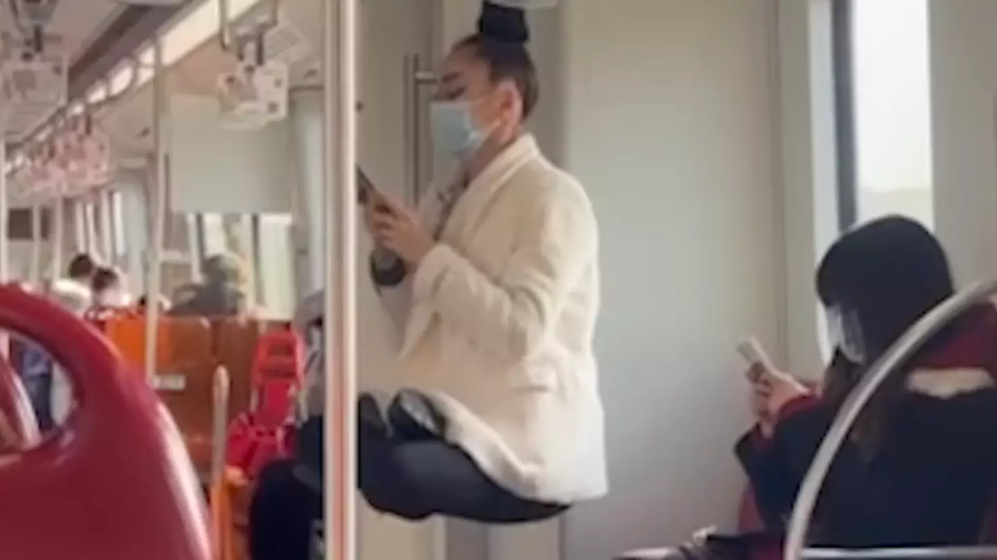 Woman Seems To Levitate As She Hangs By Her Hair On A Train