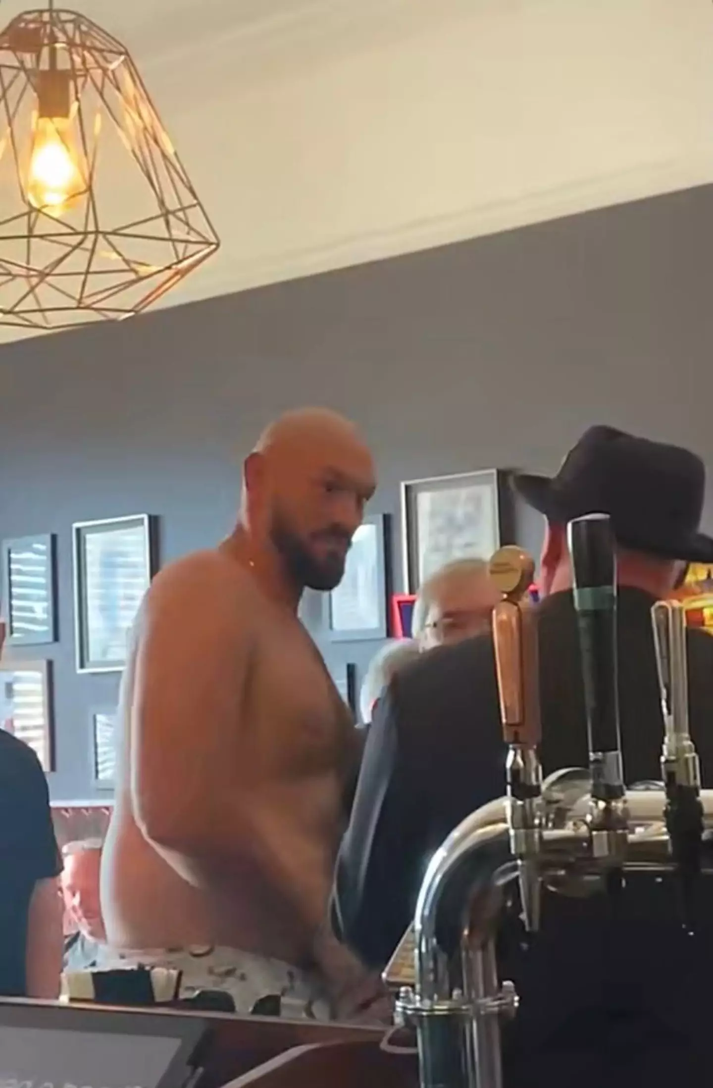 Tyson Fury whipped his top off during a trip to the pub with his mates.