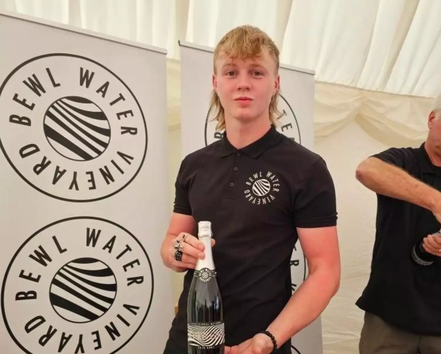 Ashton with a bottle of his award-winning wine.