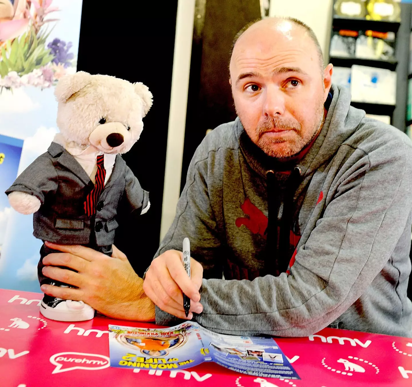 Karl Pilkington signing DVD copies of 'The Moaning of Life 2' in 2015.