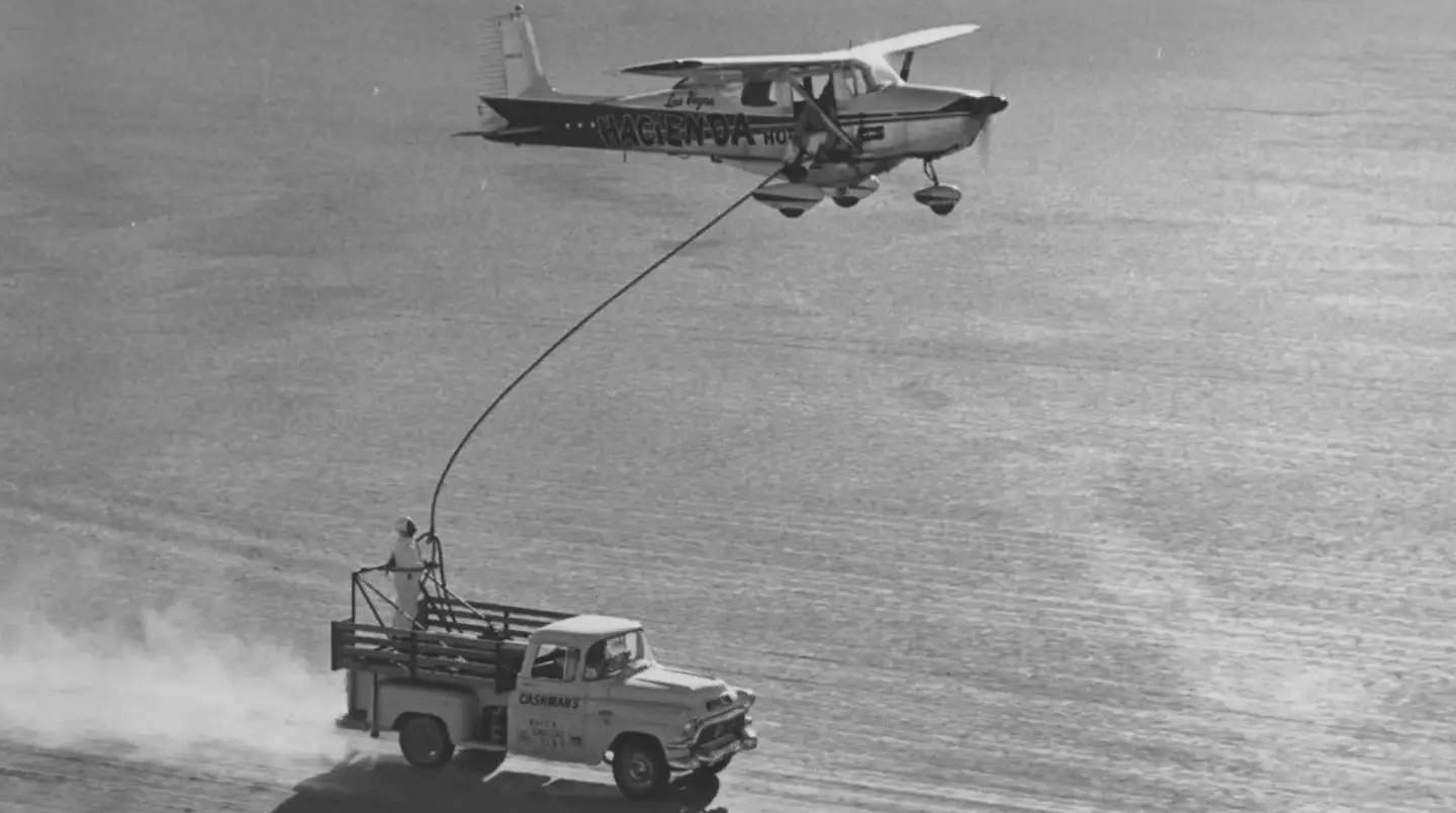 In order to refuel without landing, they flew the plane very low while a truck winched up a hose, using a pump to transfer the fuel to the aircraft.
