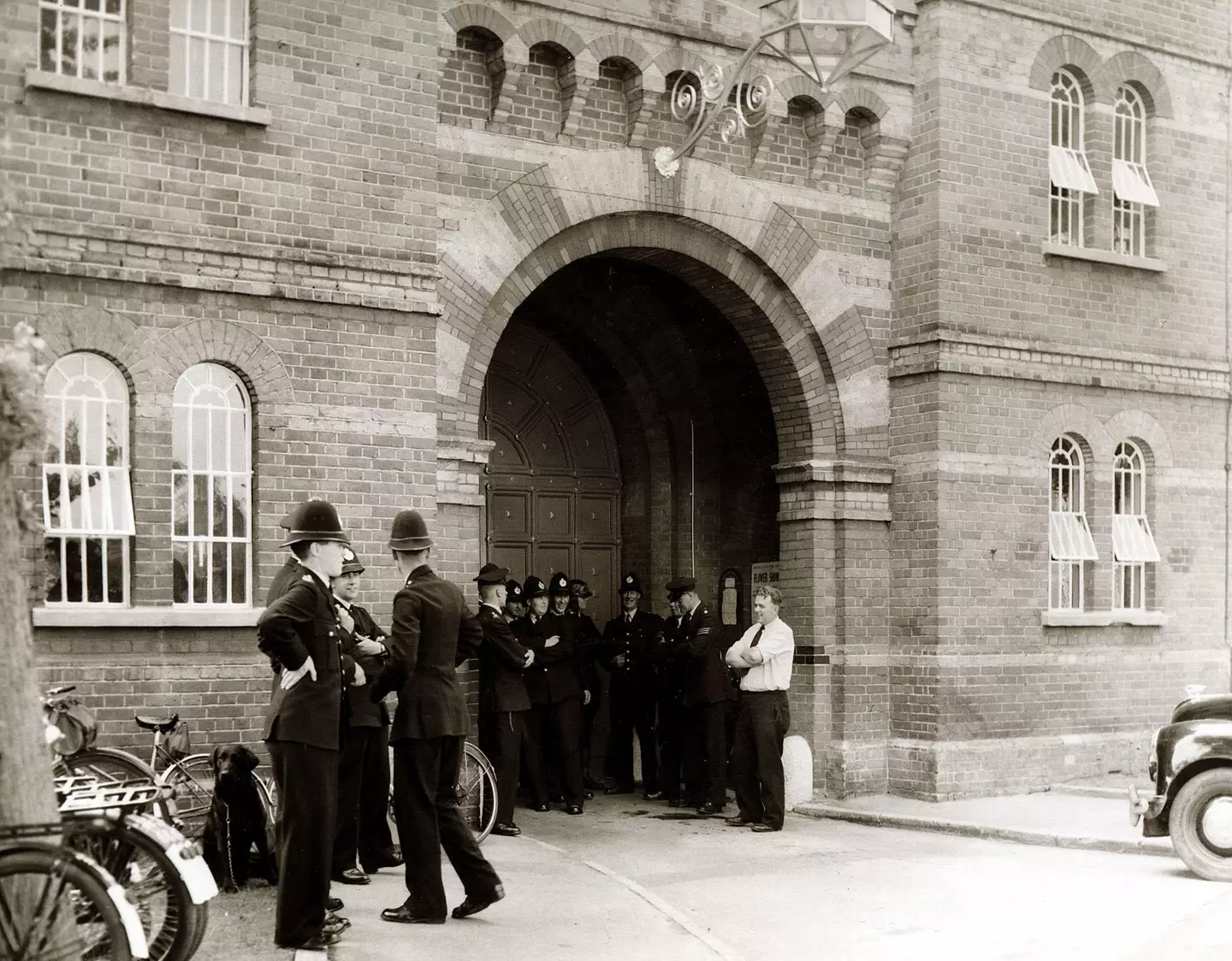 Police officers of the Berkshire Constabulary standing outside main gate of Broadmoor after a prisoner escaped.