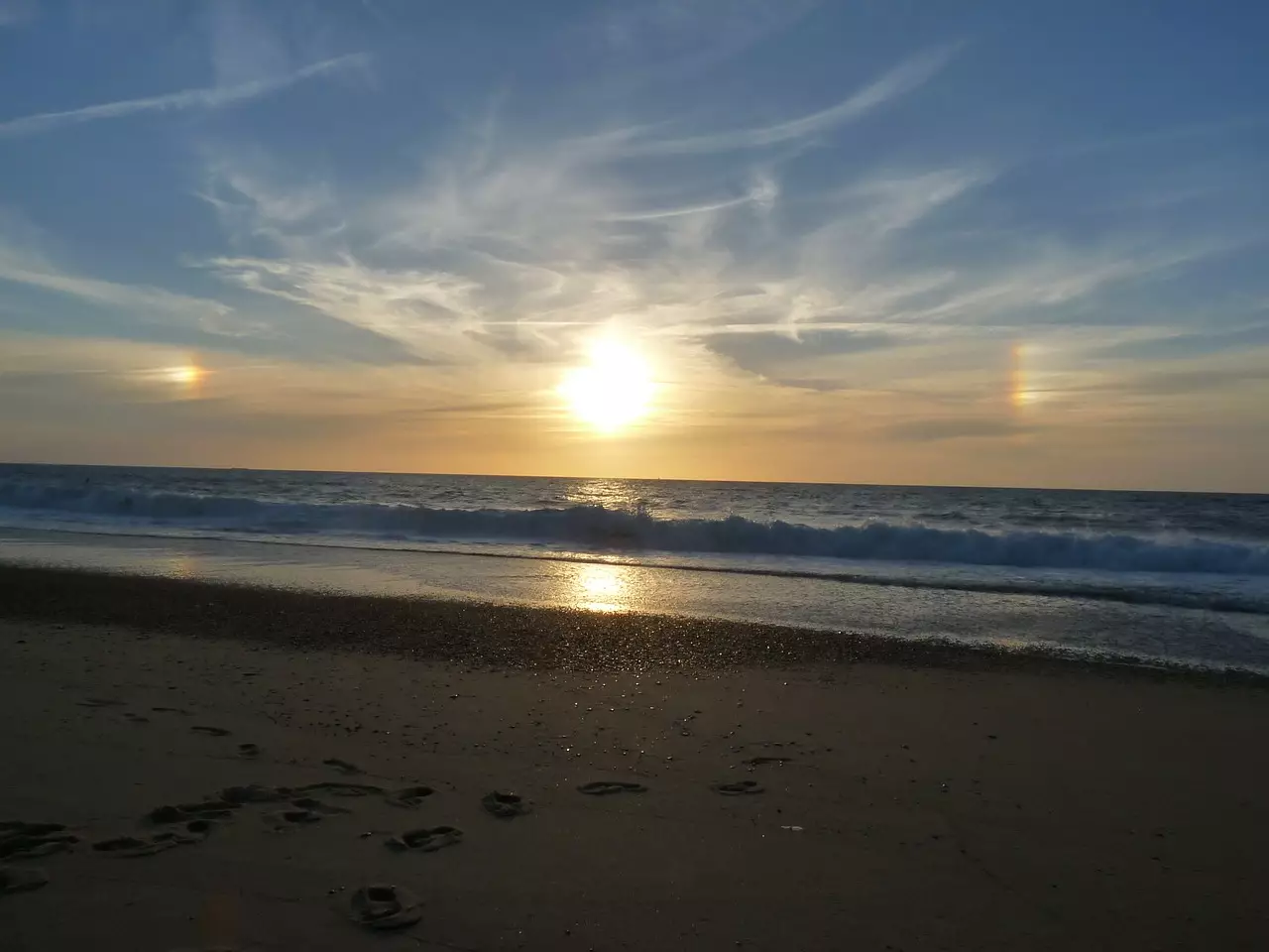 Sun dogs, or parhelia, are caused by refraction of sunlight by ice crystals in the atmosphere