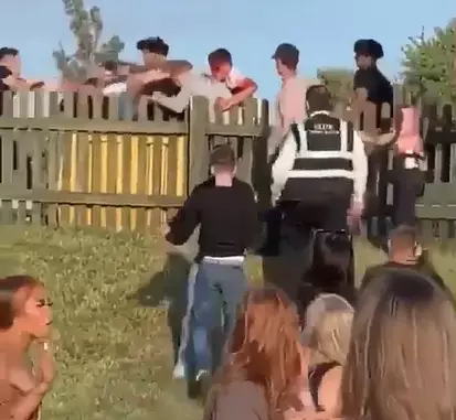 Security staff are seen trying to break up a fight.