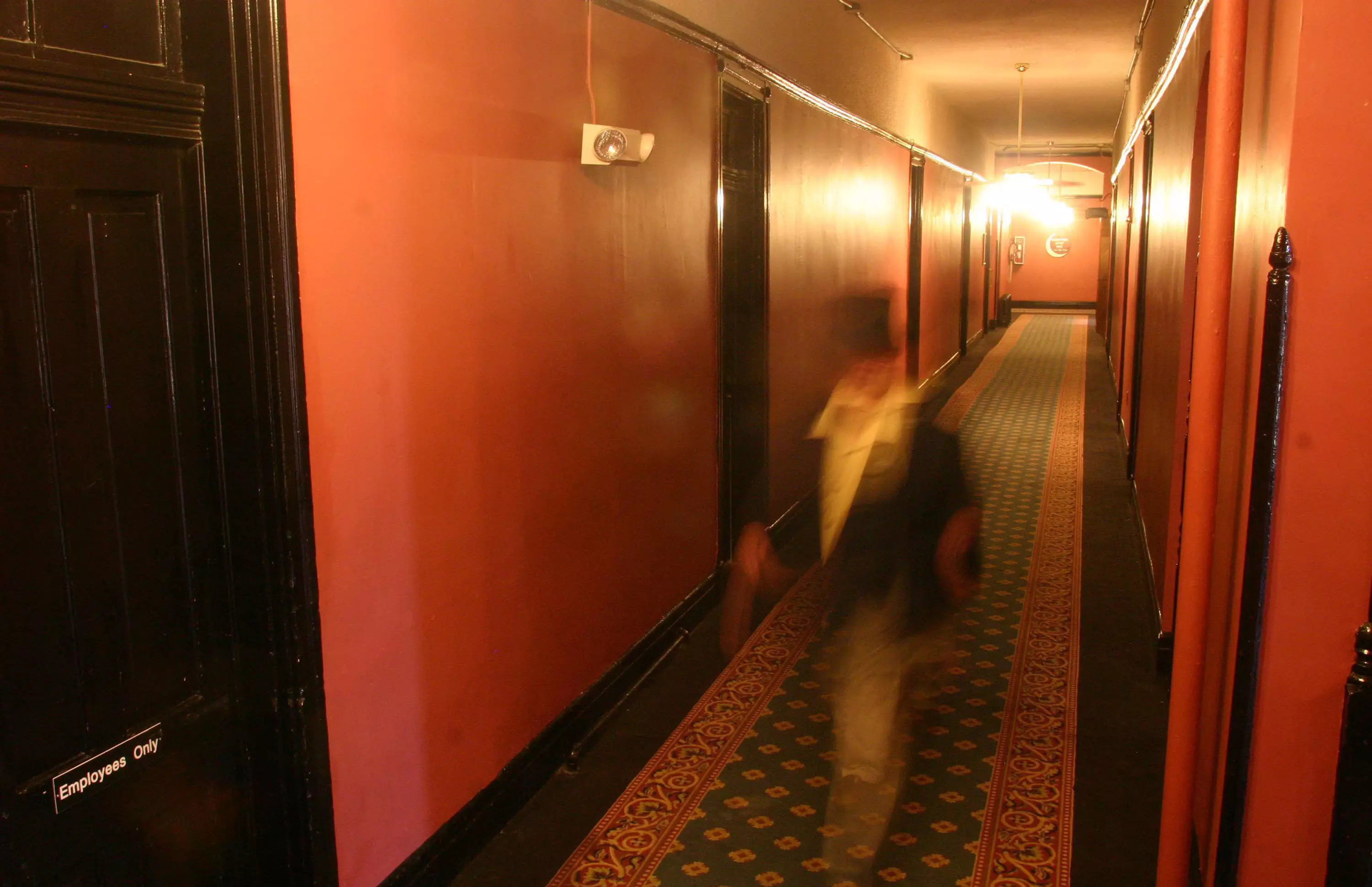 A ghoulish figure treads the hallways (actually just a dude in a top hat shot with a slow shutter speed).