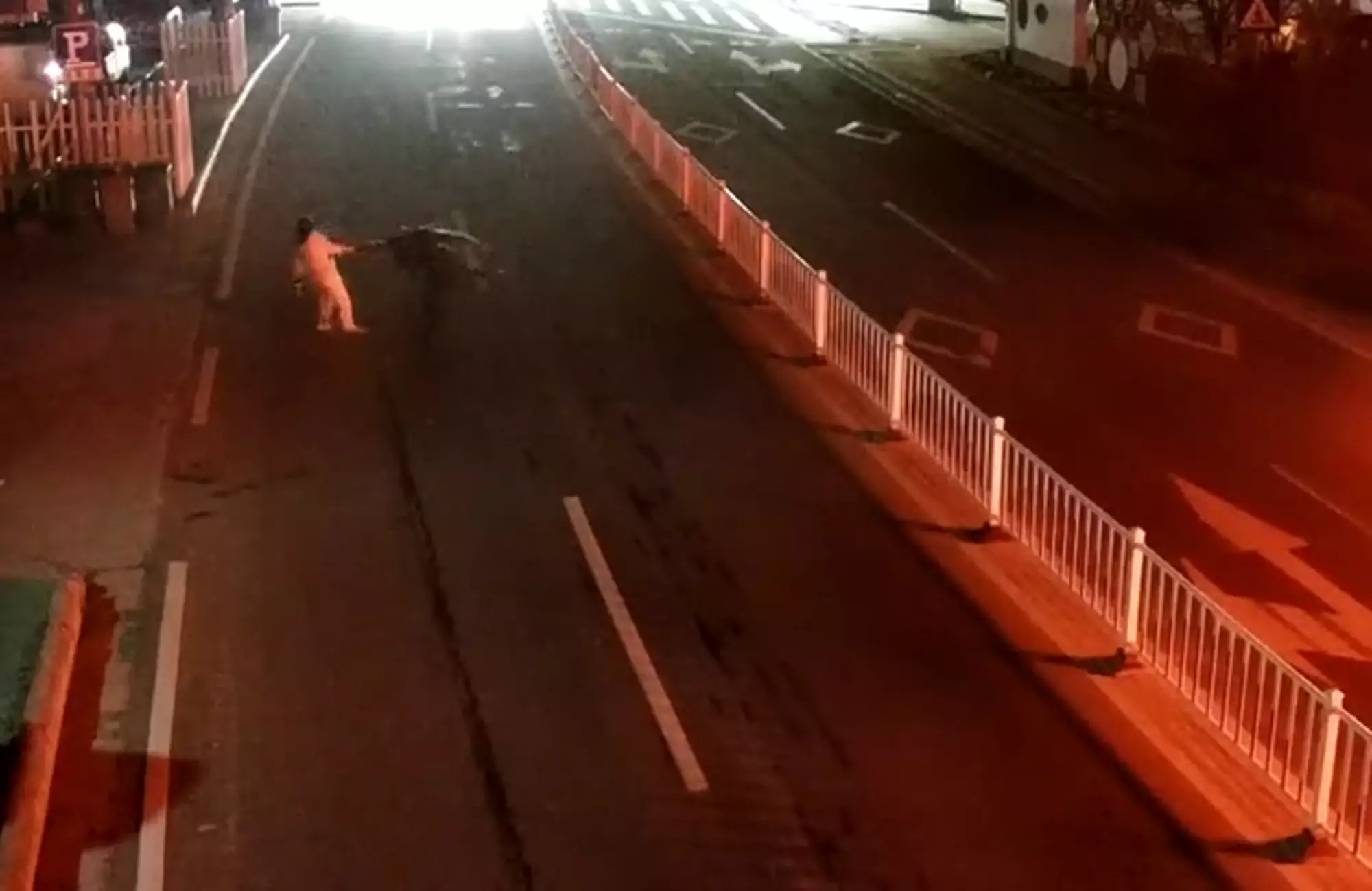 The man and the woman fighting in the middle of the road.