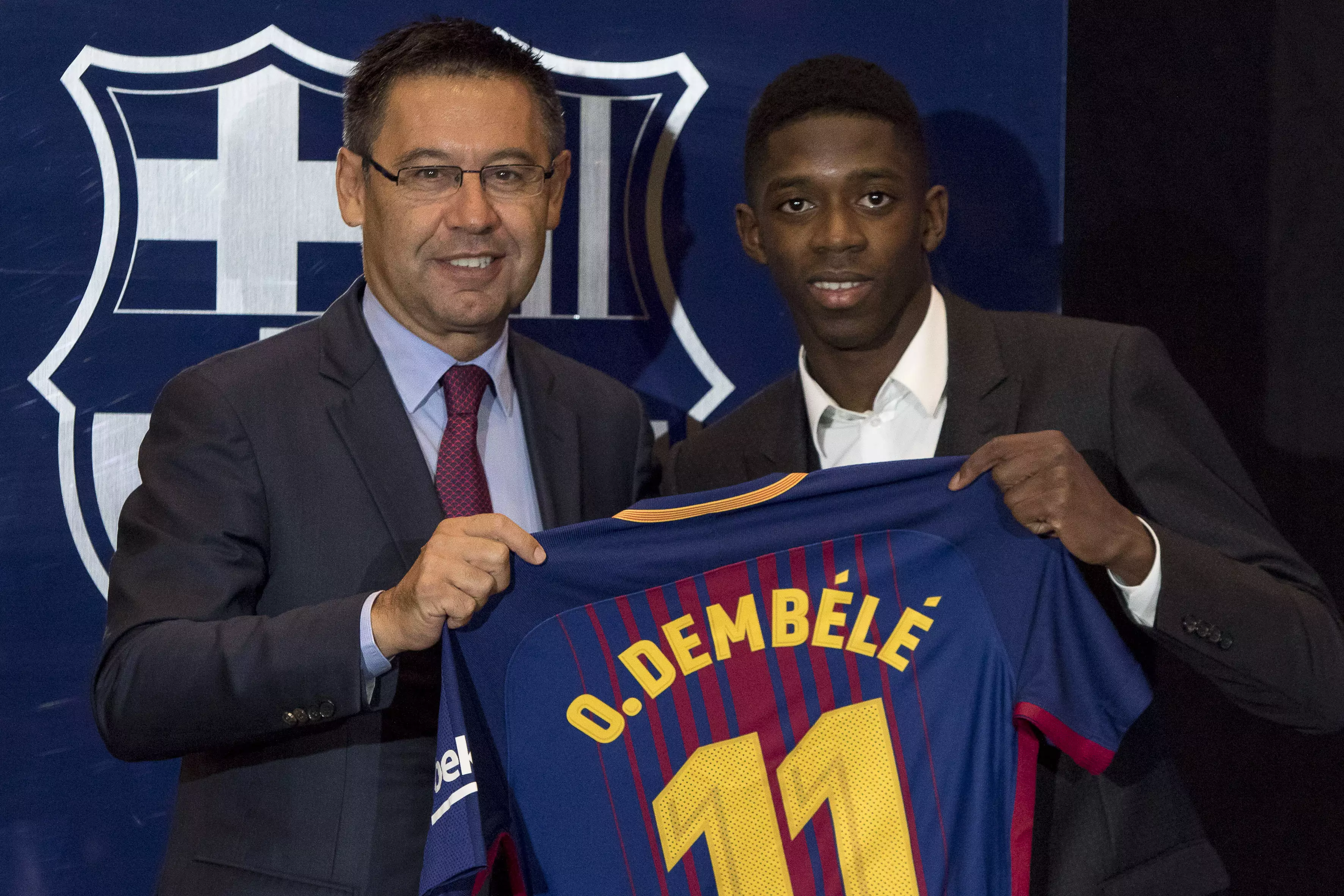 Dembele holds up a Barcelona shirt during his unveiling. Image: PA