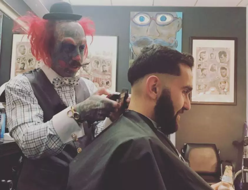 Richie pictured cutting a customer's hair.