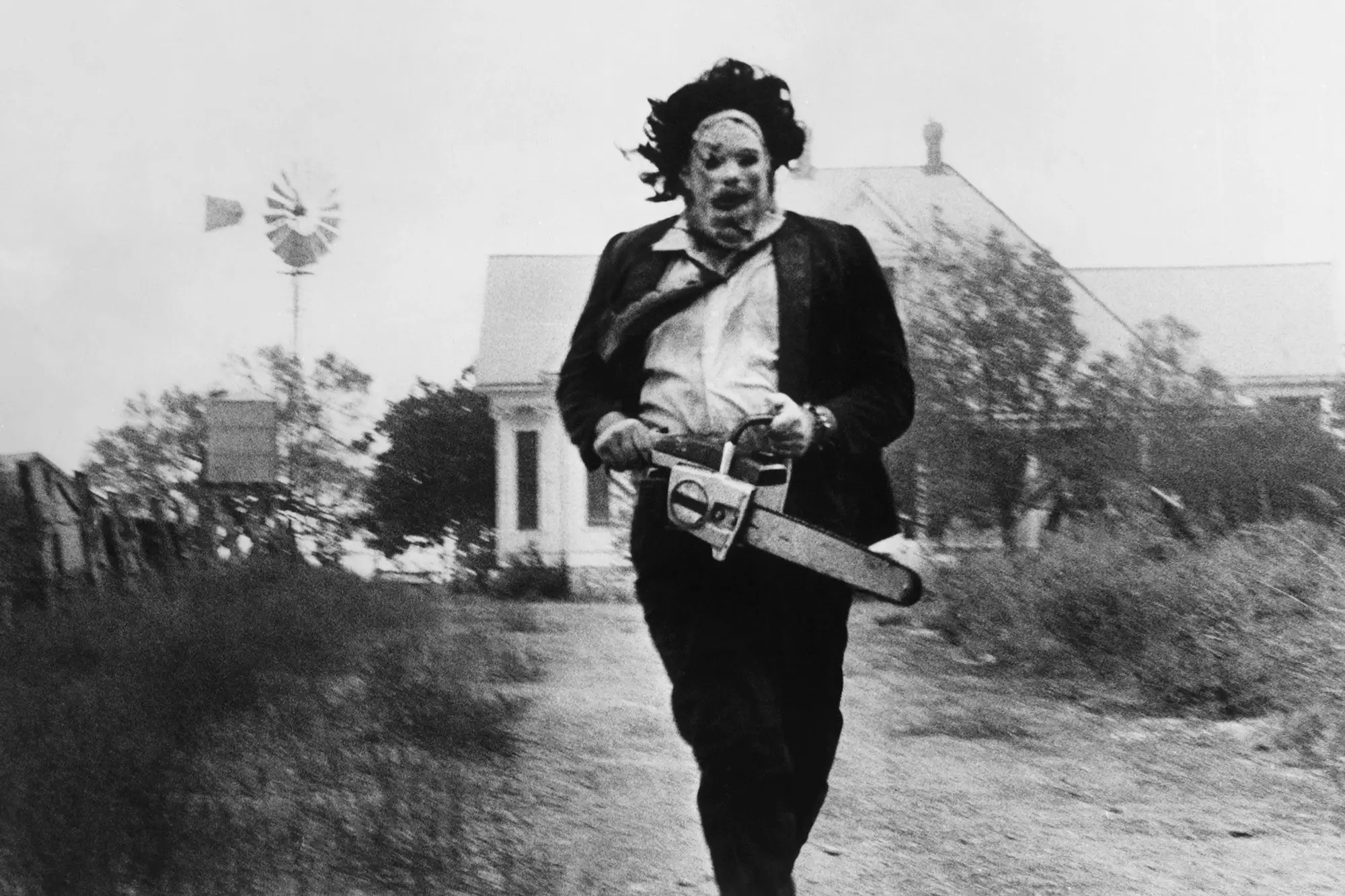 The image of Leatherface running from the Victorian house has become one of horror's most iconic shots (