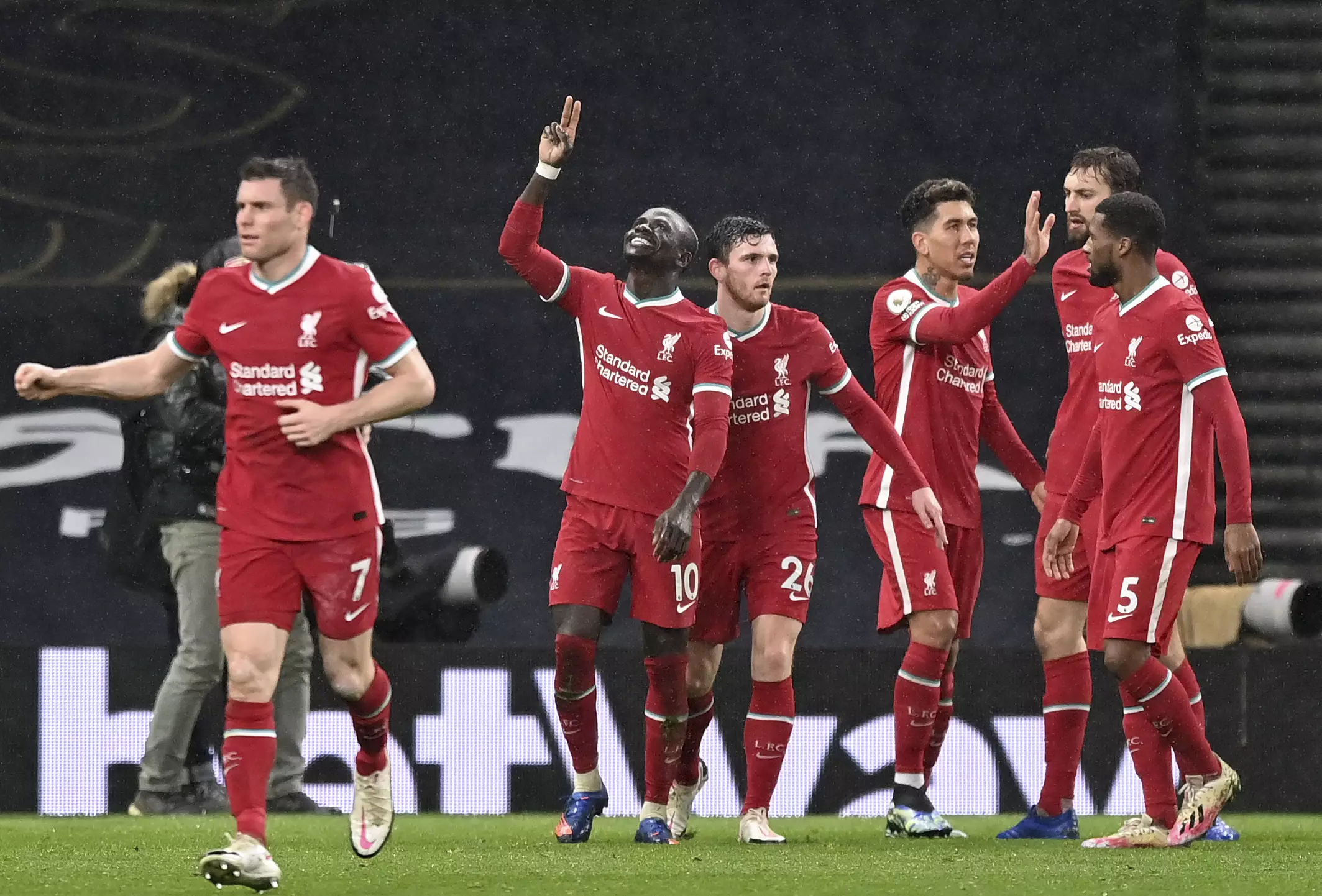 Liverpool celebrate Sadio Mane's goal, their third of the game. (Image