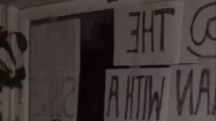 Woman Tries Chatting Up Neighbour With Signs In Window In Lockdown