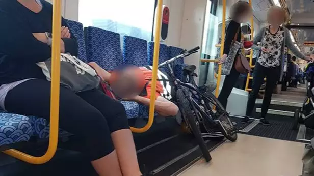 'Angry' Cyclist Sparks Outrage By Laying Across Seats On Train During Peak Hour