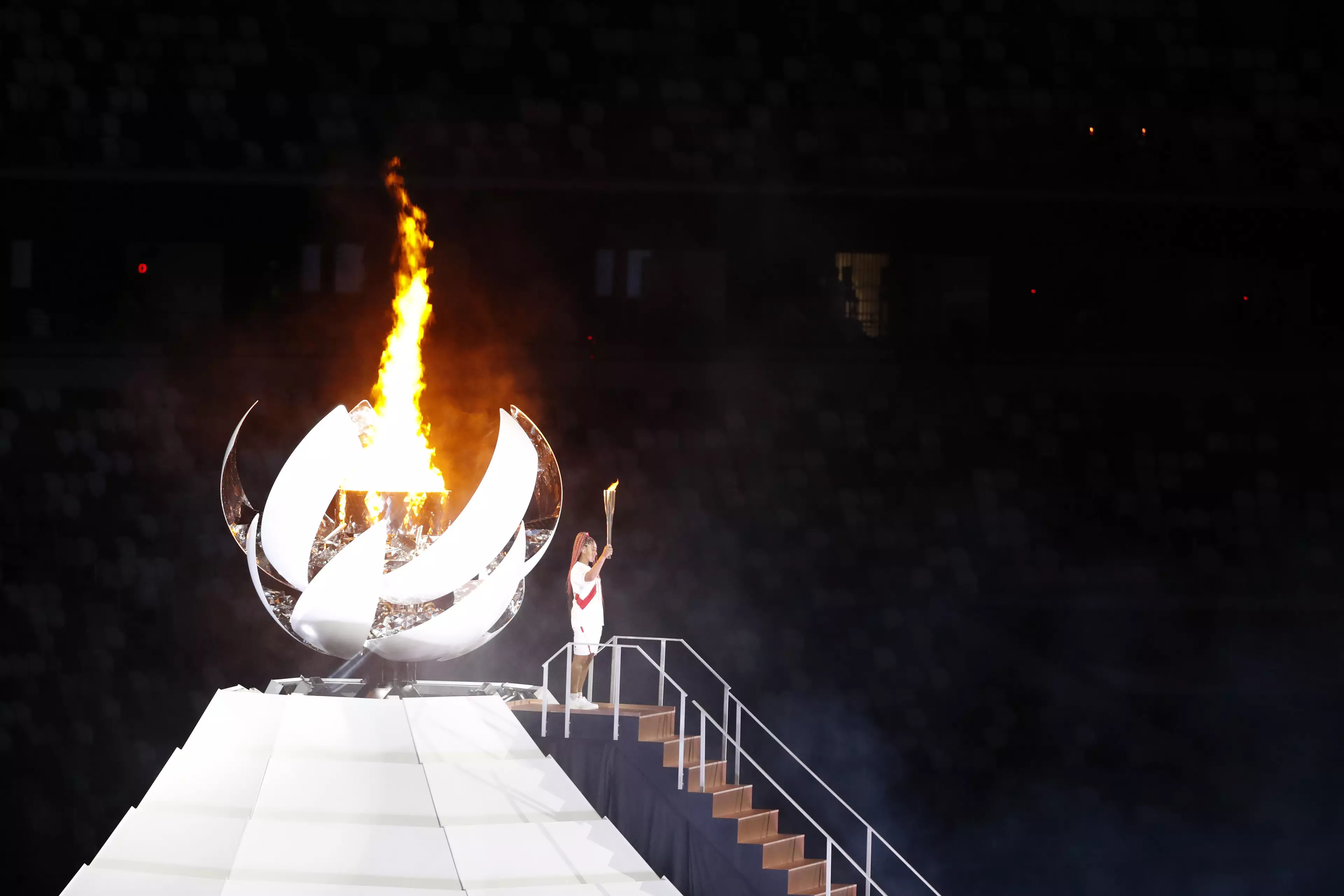 Naomi Osaka, tennis player for Japan, lights the Olympic flame at the Opening Ceremony.