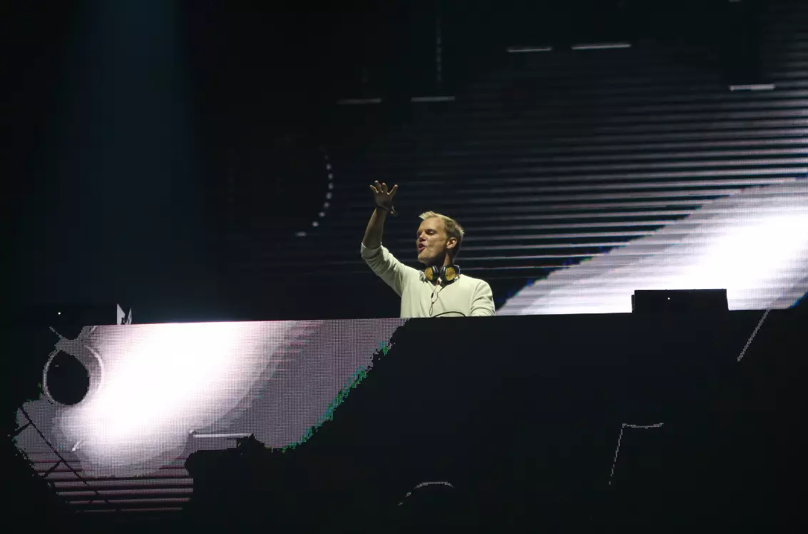 Avicii performing on stage.