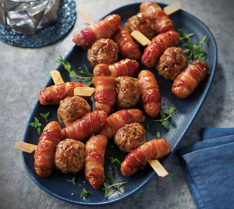 The kebabs are made up of sausages, bacon and stuffing (