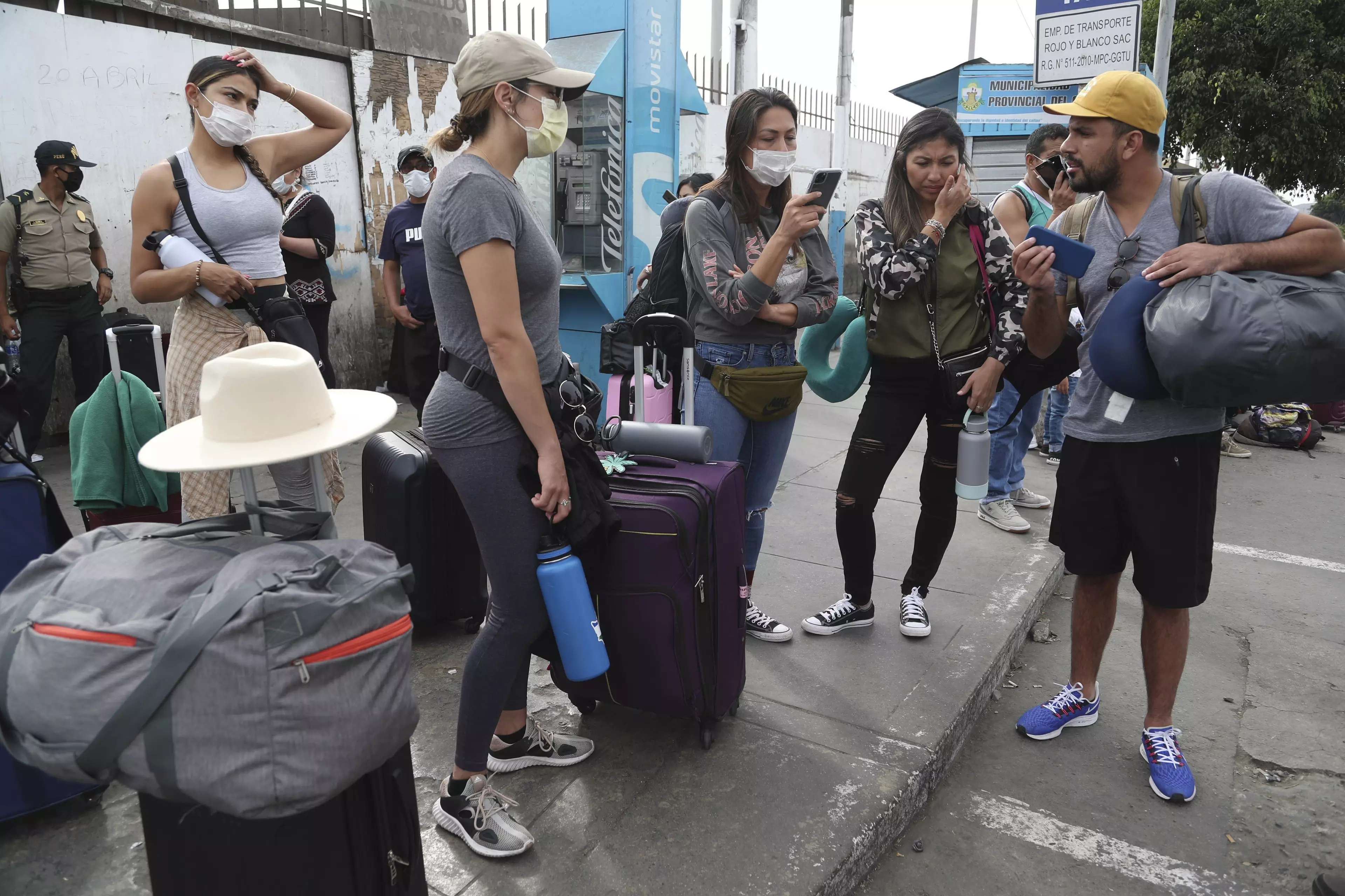 Stranded tourists wait outside the closed Jorge Chavez International Airport in Peru.