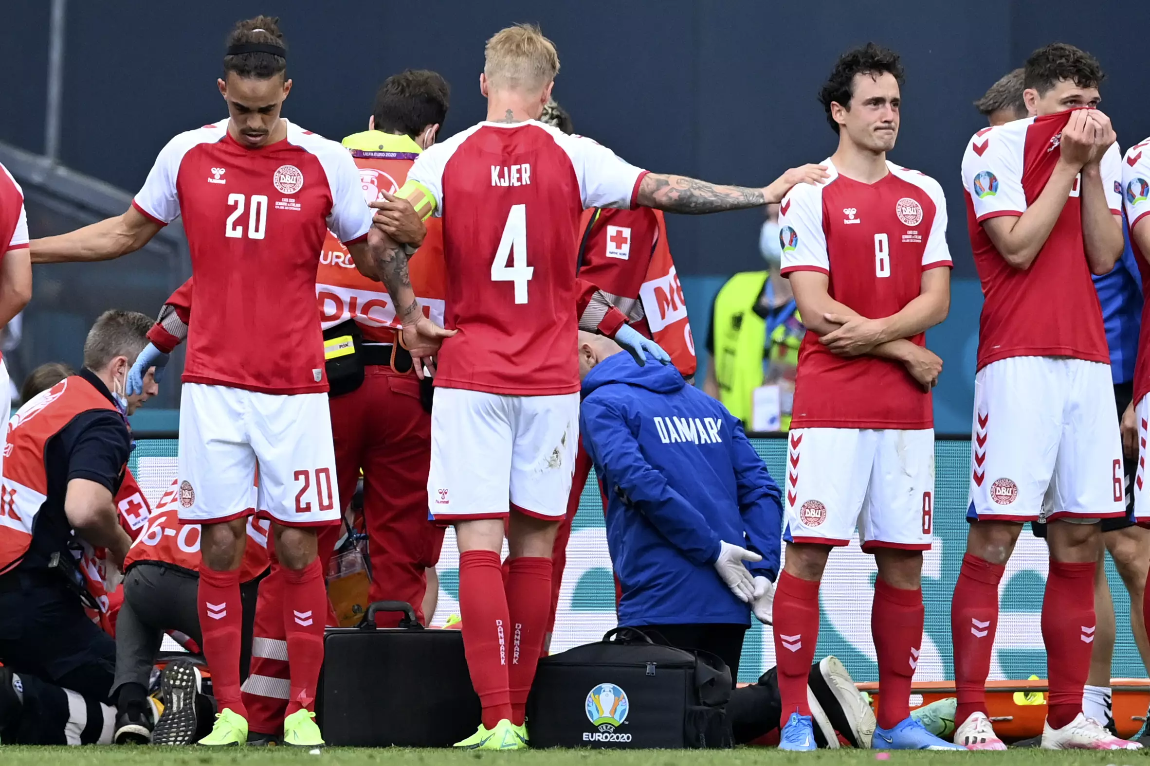 Kjaer helps console a teammate whilst they formed a circle around Eriksen. Image: PA Images