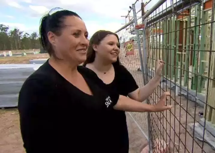 Madison and her mum at the site where her new home is being built.
