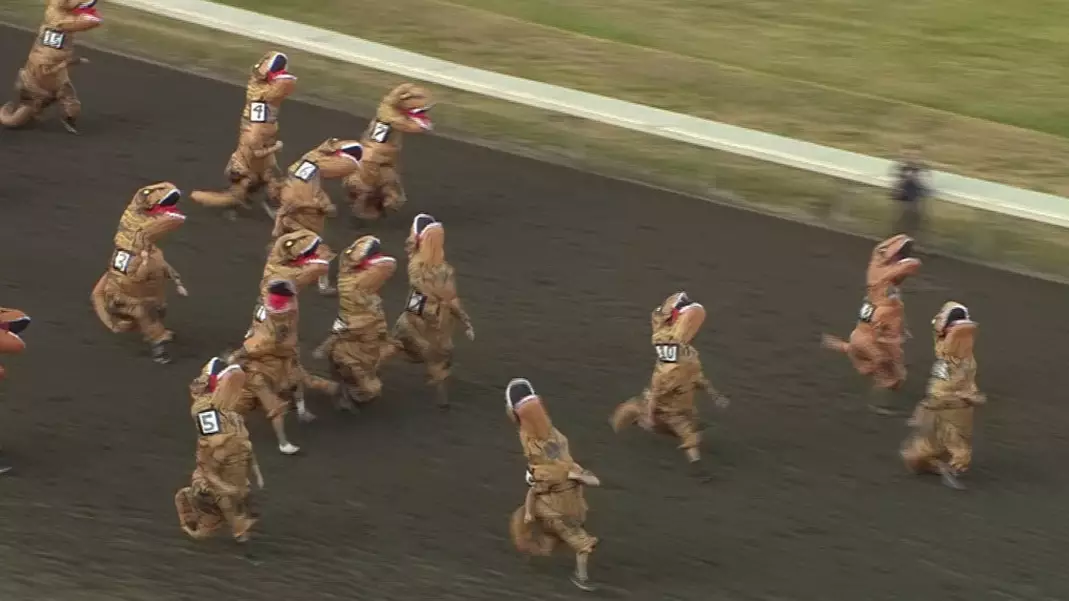 Hilarious Video Shows People In T-Rex Costumes Racing Around Horse Track