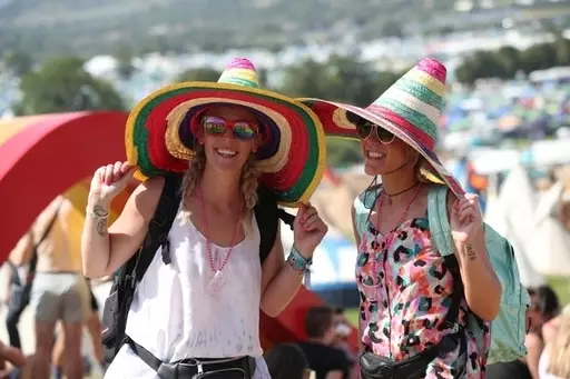 Festival goers enjoying the sun during Glastonbury Festival.