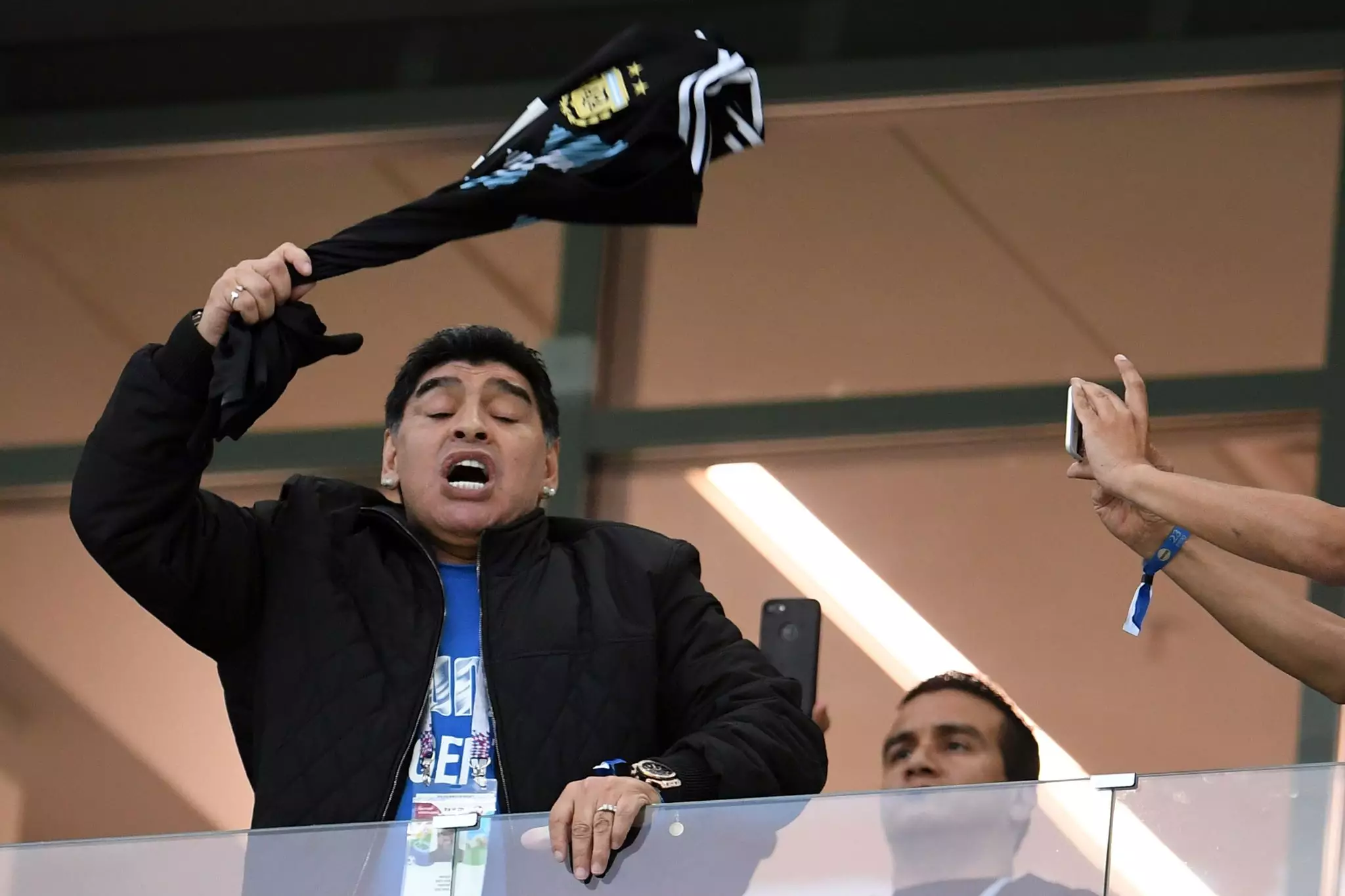 Maradona waves a Messi shirt. Image: PA