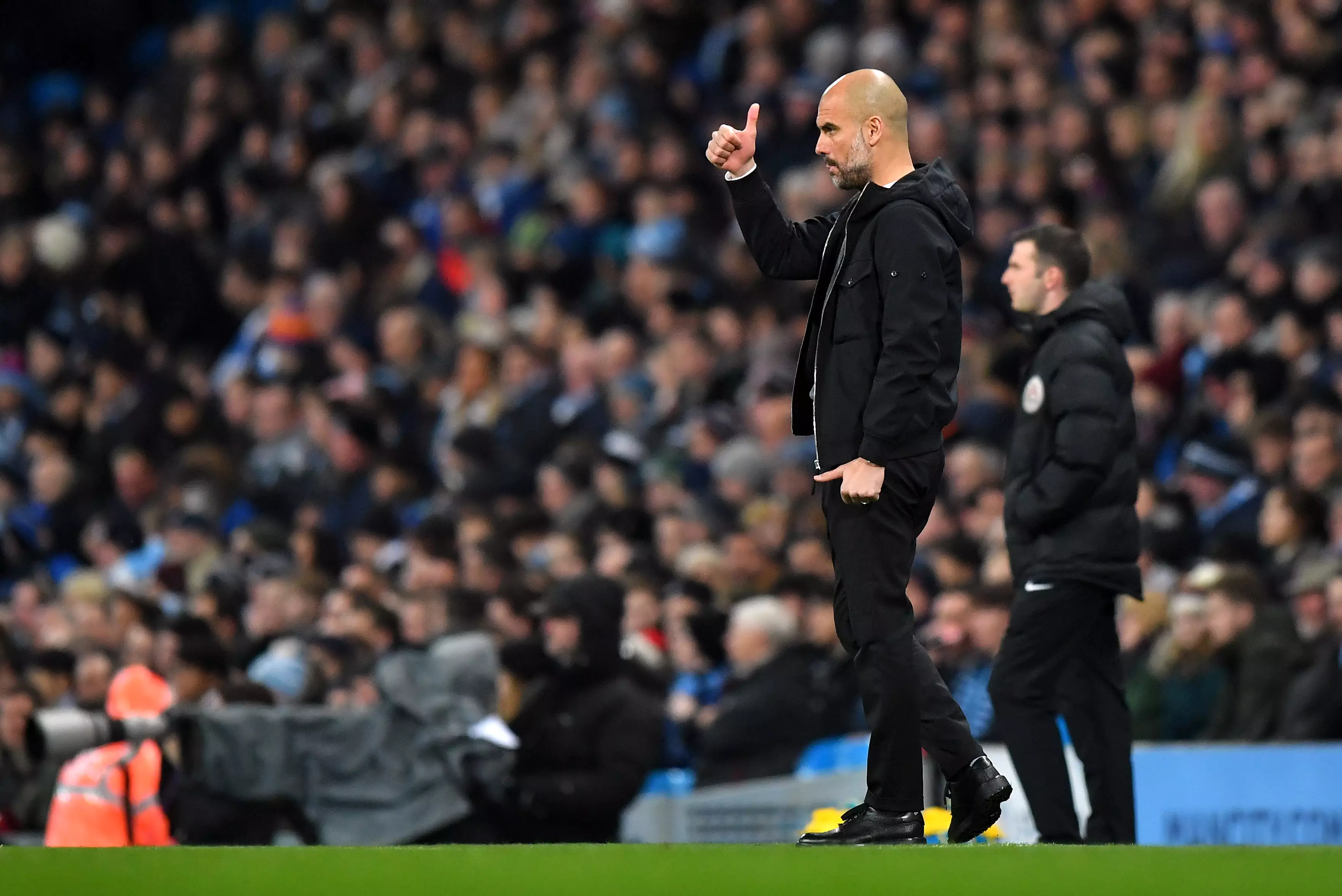 Guardiola gestures on the touchline. Image: PA